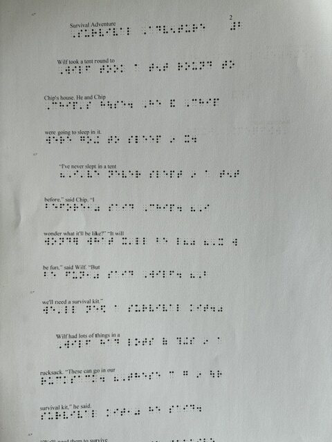 Close-up of a Braille reading page titled “Survival Adventure,” with printed text and corresponding embossed Braille.